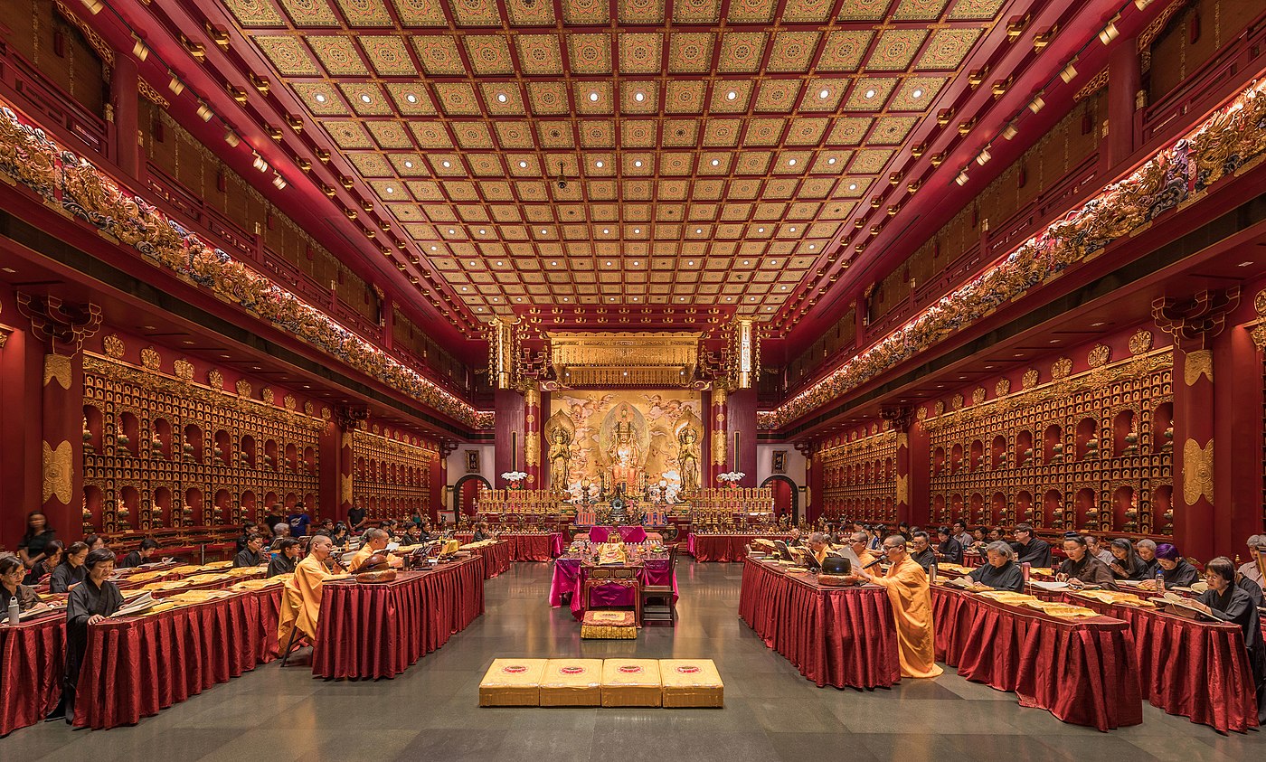 Praying monks and nuns in the Buddha Tooth Relic Temple of Singapore